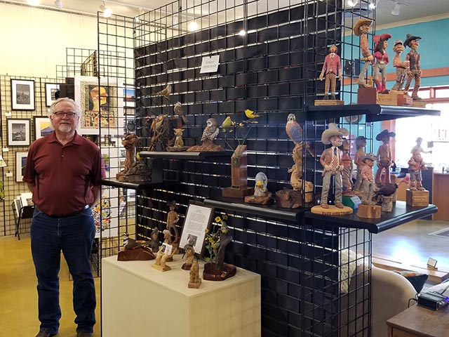 Rob Arnberger with his carvings at the Creative Spirit Artists Gallery in Patagonia, Arizona